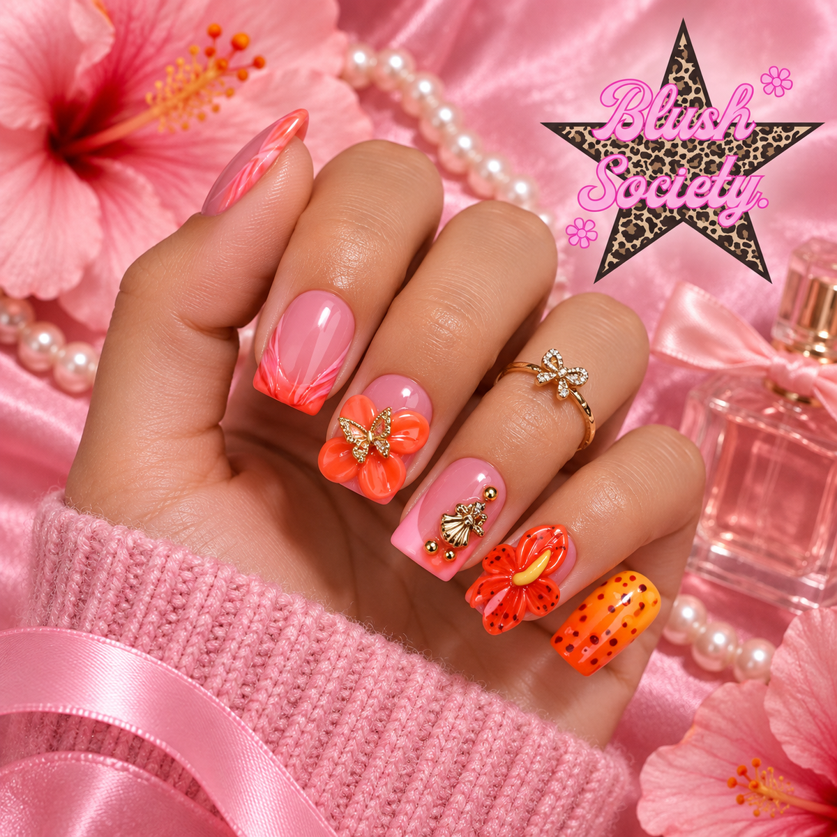 Coral Butterfly press-on nails modeled on hand