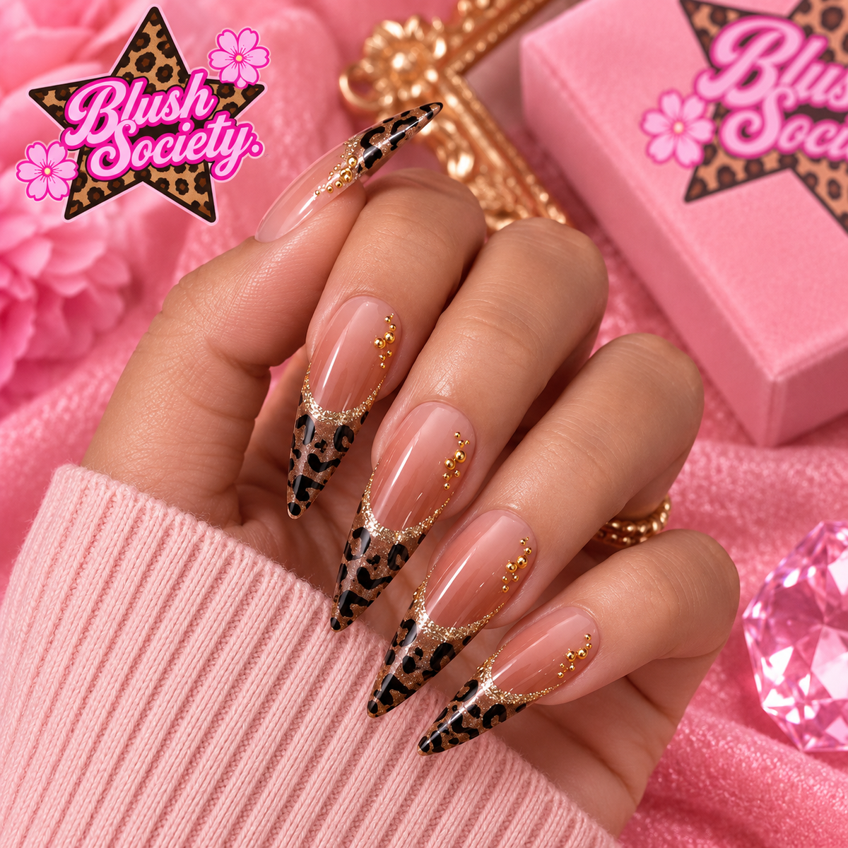 Leopard Luxe long stiletto press-on nails modeled on a hand